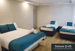 Deluxe family room with a queen bed and single beds